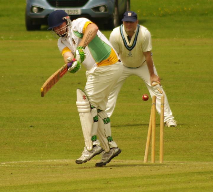 Phil Hay is bowled by Archie Thomas at The Racecourse